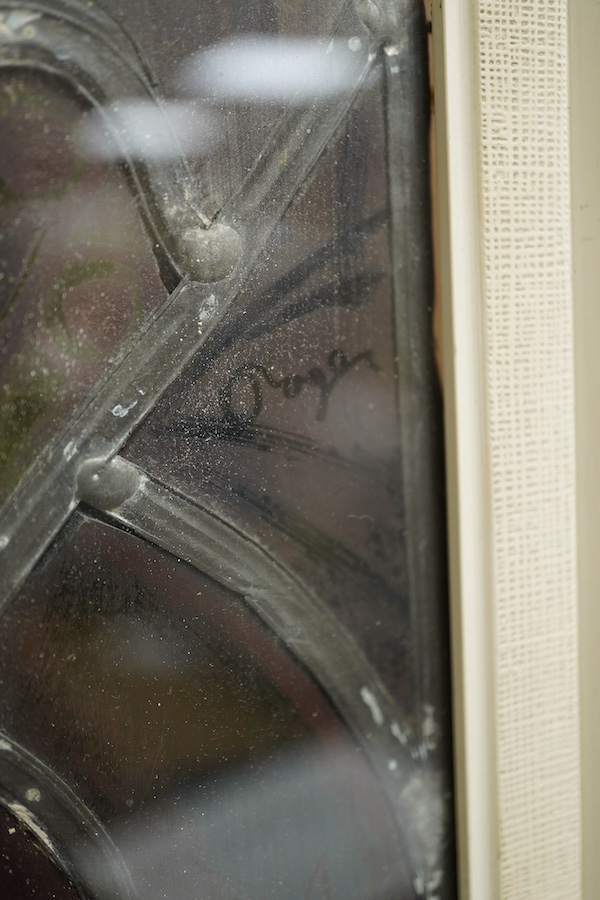 A stained and leaded glass panel of a romantic couple in front of a cathedral, 48cm high